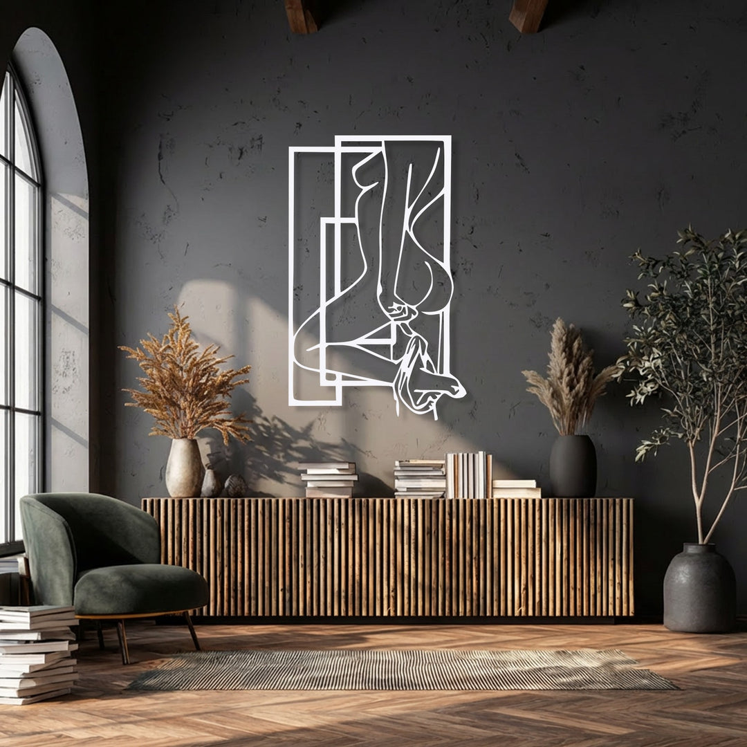 The subdued color saturation highlights the abstract feminine silhouette metal wall decor with its distinct geometric frames.