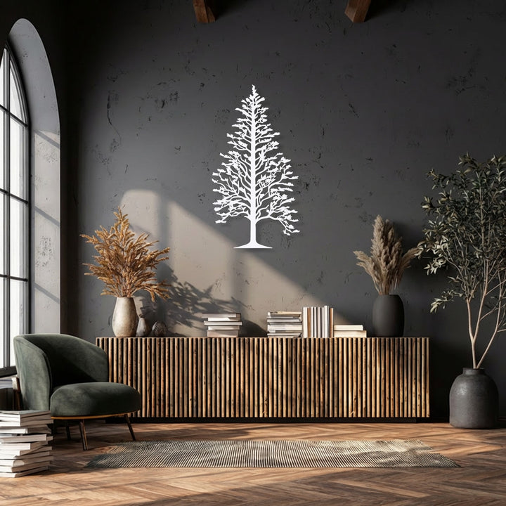 The brightest area is dominated by an elegant white pine tree silhouette, a stunning piece of decorative metal art, vividly contrasting the dark wall.