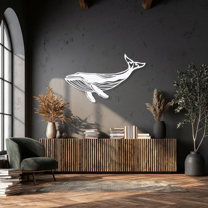 Against a dominant dark grey backdrop, a unique metal wall art piece depicts a majestic white whale silhouette.