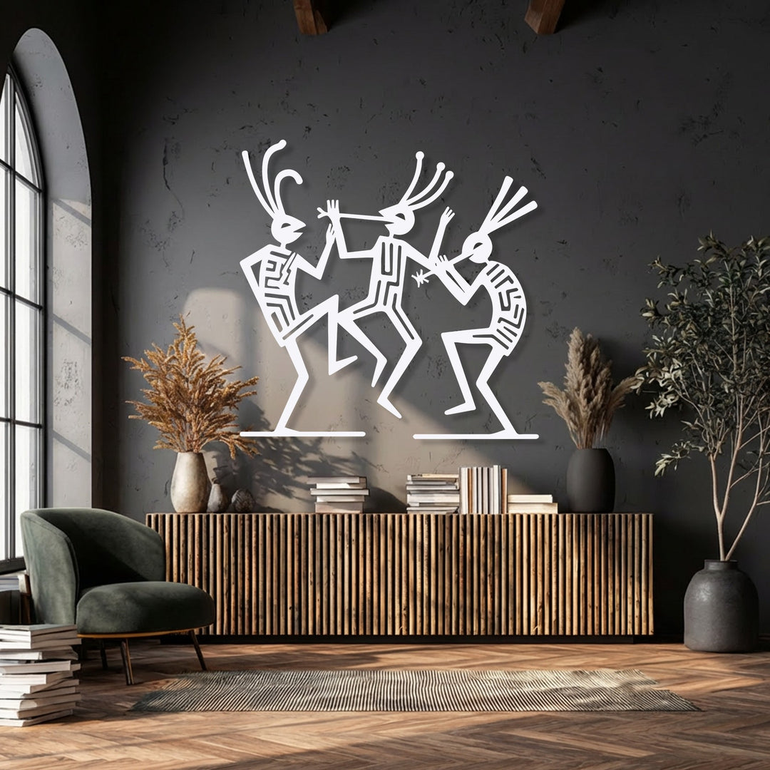 The abstract quality of three white dancing tribal figures in this metal wall decor piece brings a dynamic rhythm to the textured dark grey wall.
