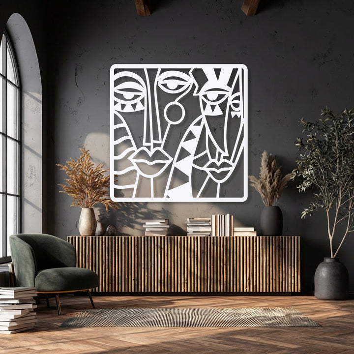 The organic forms of abstract cubist faces create a striking composition in this unique metal wall art piece.