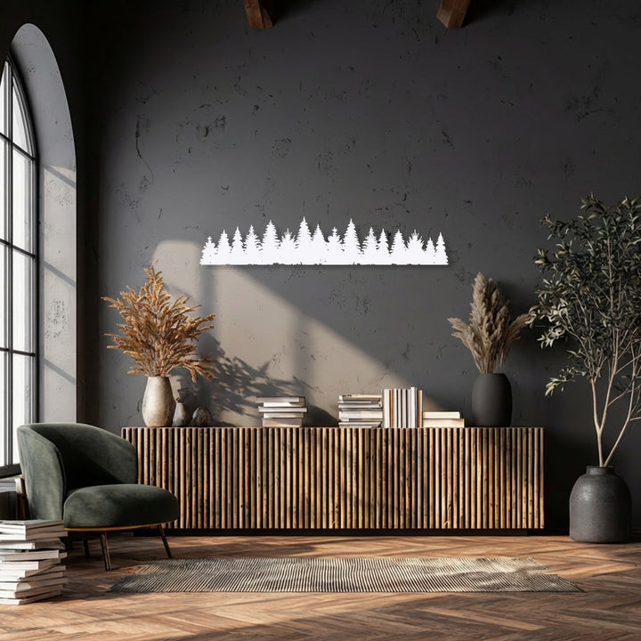 The serene mood of this living space is enhanced by a unique metal wall art depicting a minimal pine forest silhouette.