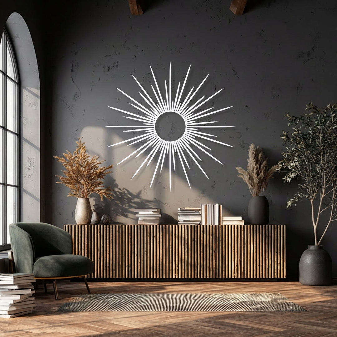 The radiant sunburst unique metal wall art features a smooth, matte white finish that stands out against the dark wall.