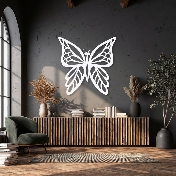 The distinct, clean edges of the white decorative metal art butterfly beautifully contrast the textured dark wall.