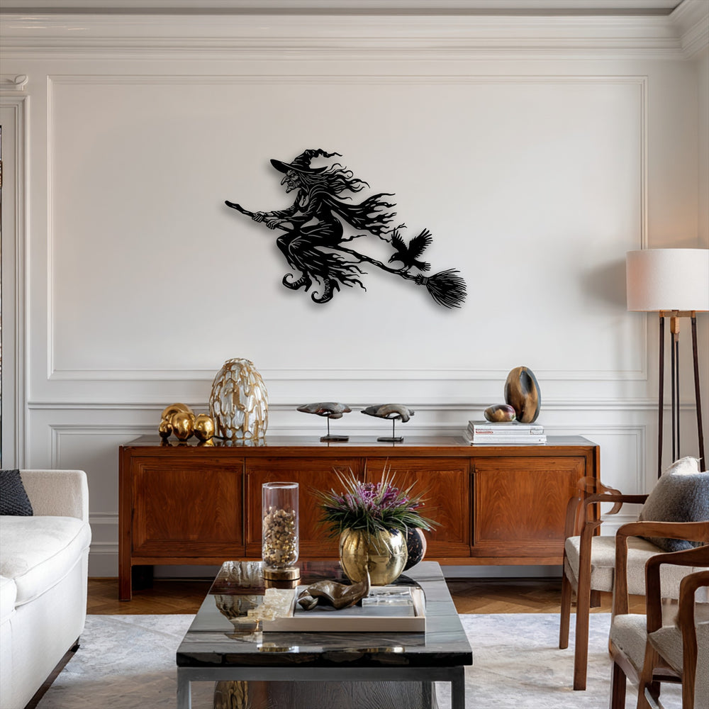 Vivid color transition from the dark flying witch unique metal wall art to the bright wall, softened by warm wood and gold decor.