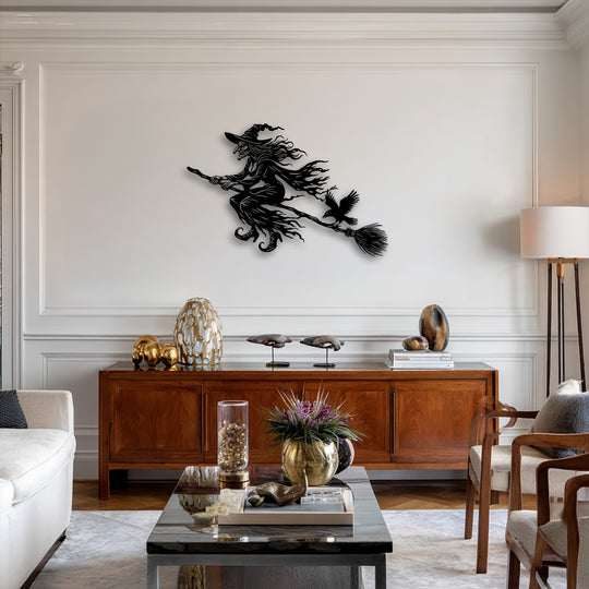 Vivid color transition from the dark flying witch unique metal wall art to the bright wall, softened by warm wood and gold decor.