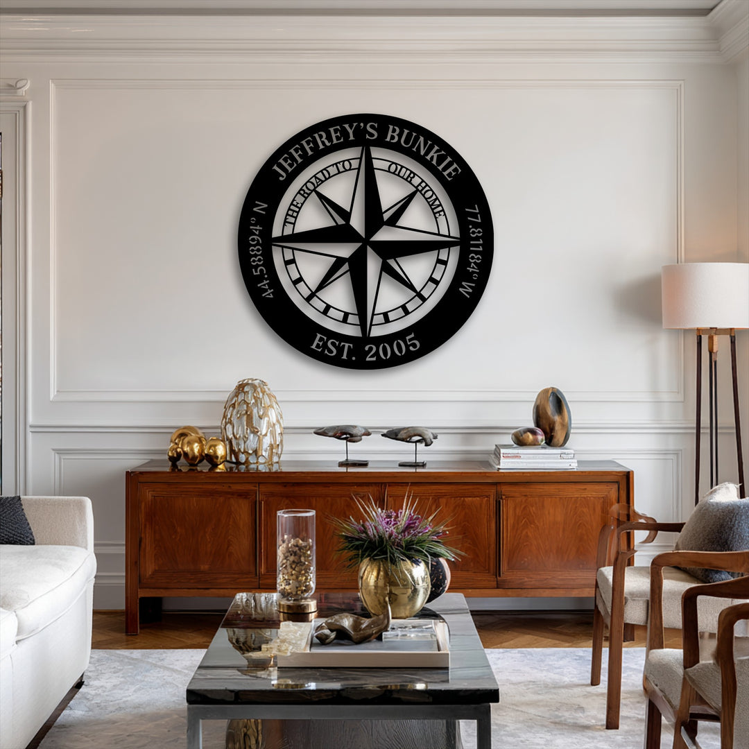 Showcasing significant depth, a personalized compass metal art for wall stands out from a paneled wall above a layered wooden console.