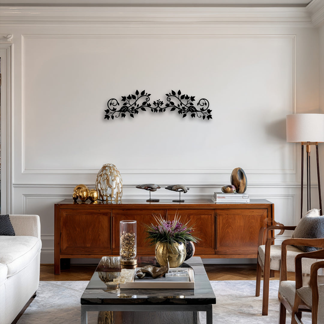 The elegant floral vine decorative metal art, featuring an intricate botanical scroll design, serves as the focal point above a rich wooden console.