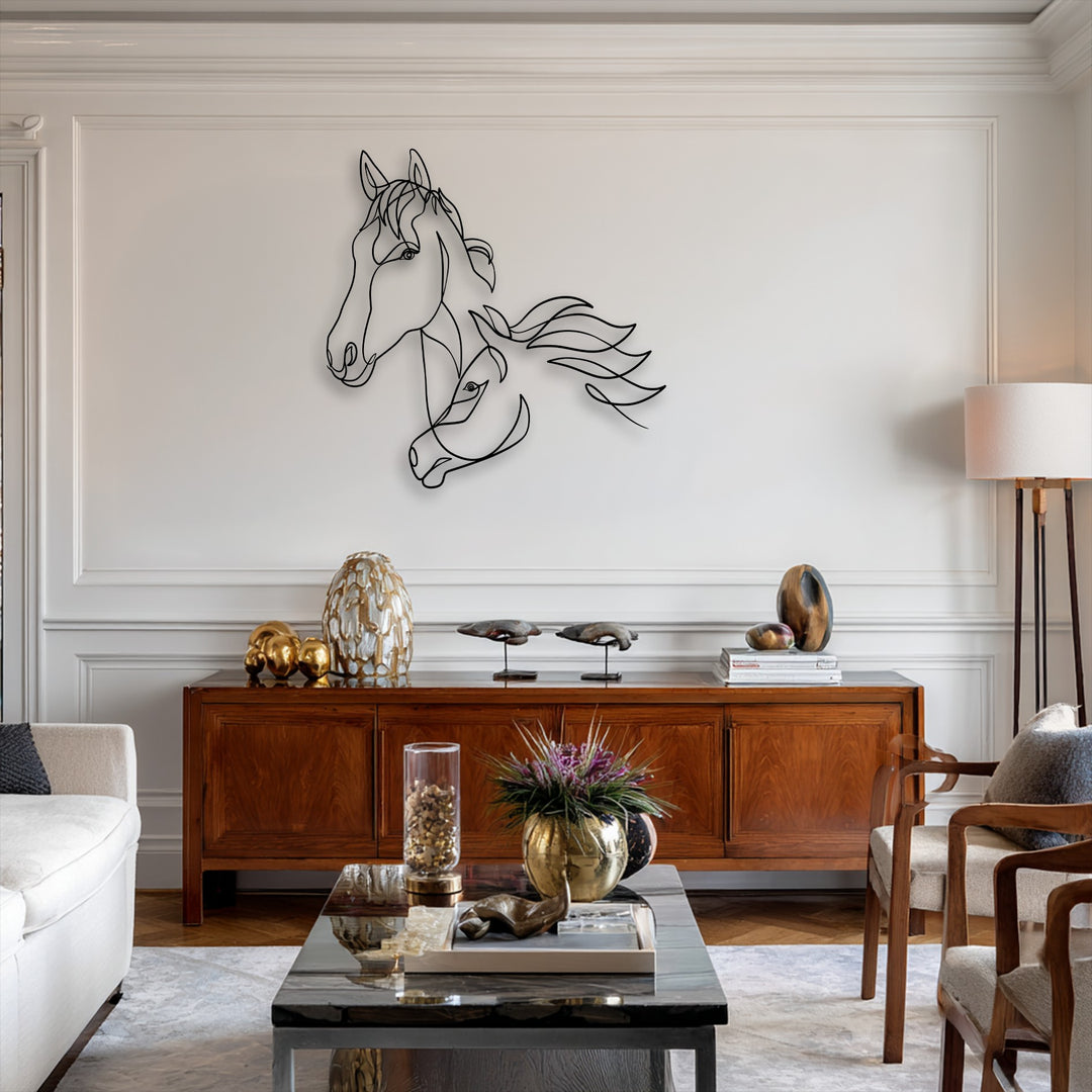 A striking minimalist dual horse line art metal wall decor piece with a flowing design is centered on a white wall.