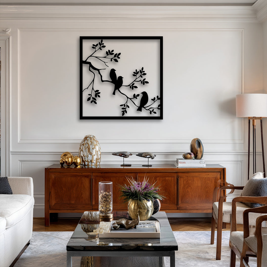 The soft beige armchair cushions provide comfort, harmonizing with the unique birds on branch metal wall art decoration wall art.