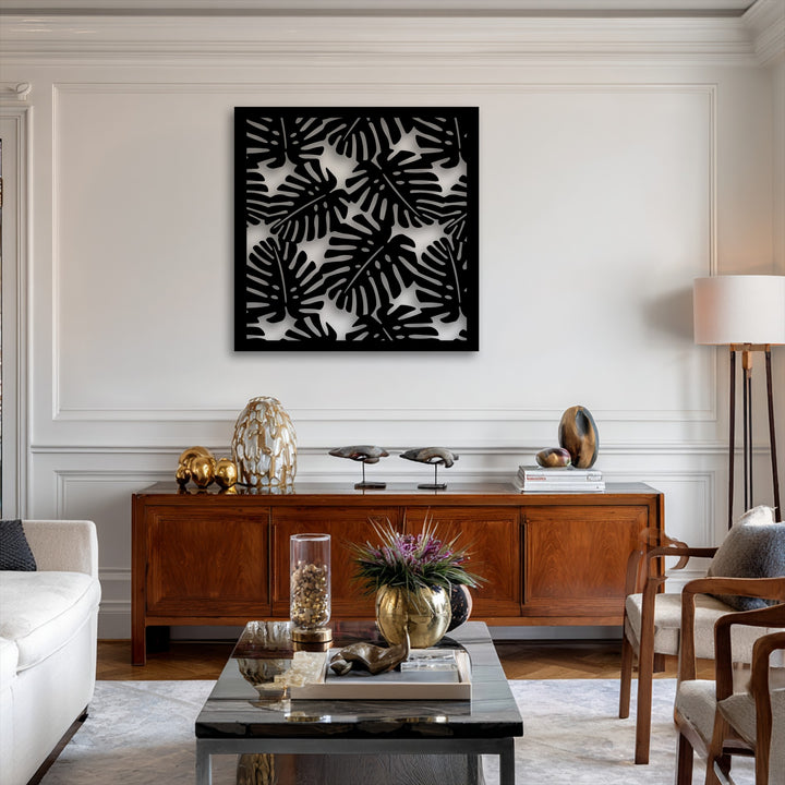 The organic forms of tropical monstera leaves create a stunning modern metal art for wall, featuring a bold black silhouette pattern.