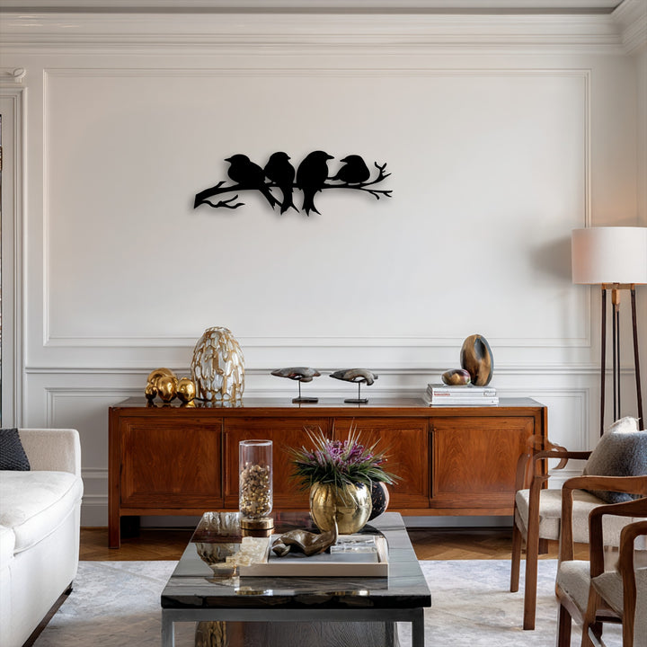 A horizontal silhouette metal art for wall depicts four birds perched on a gracefully flowing branch, offering a tranquil shape.