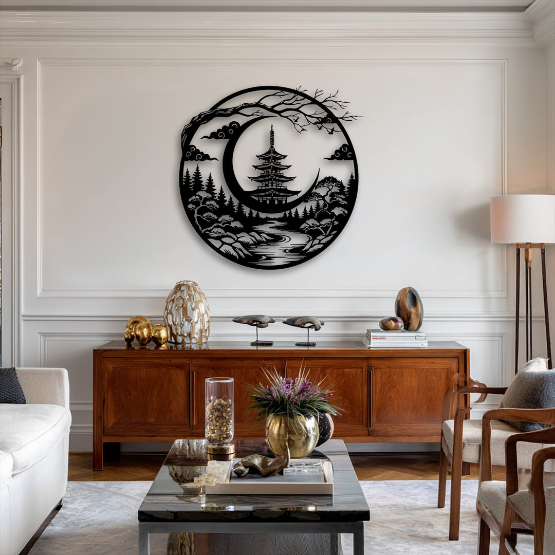 A circular decorative metal art piece showcases a serene Japanese pagoda nestled within a crescent moon landscape, surrounded by intricate trees and clouds.