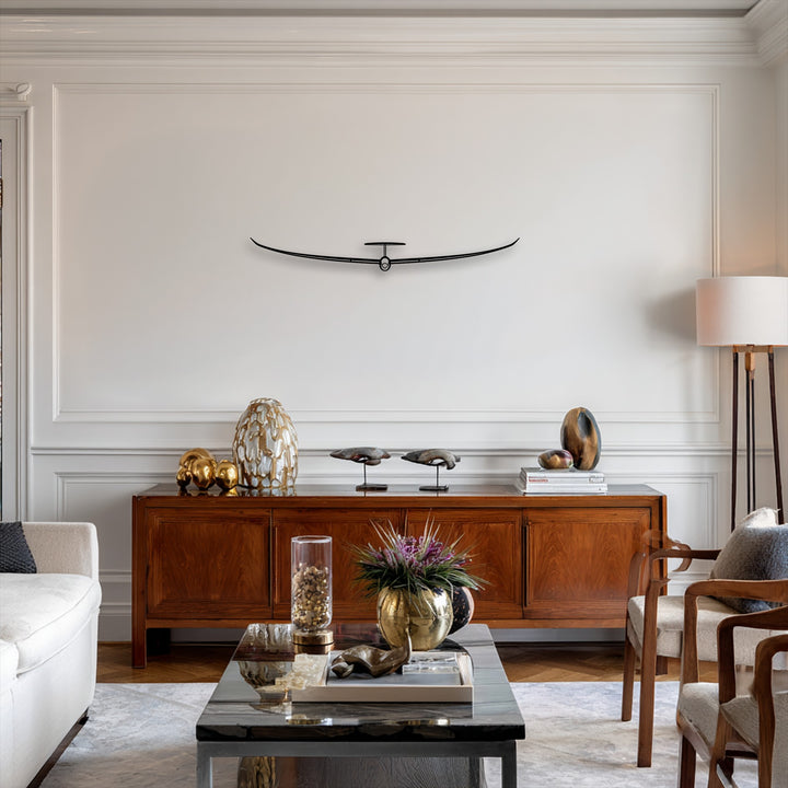 The superior material quality of this sleek black metal artwork, depicting a minimalist glider, enhances the contemporary decor.