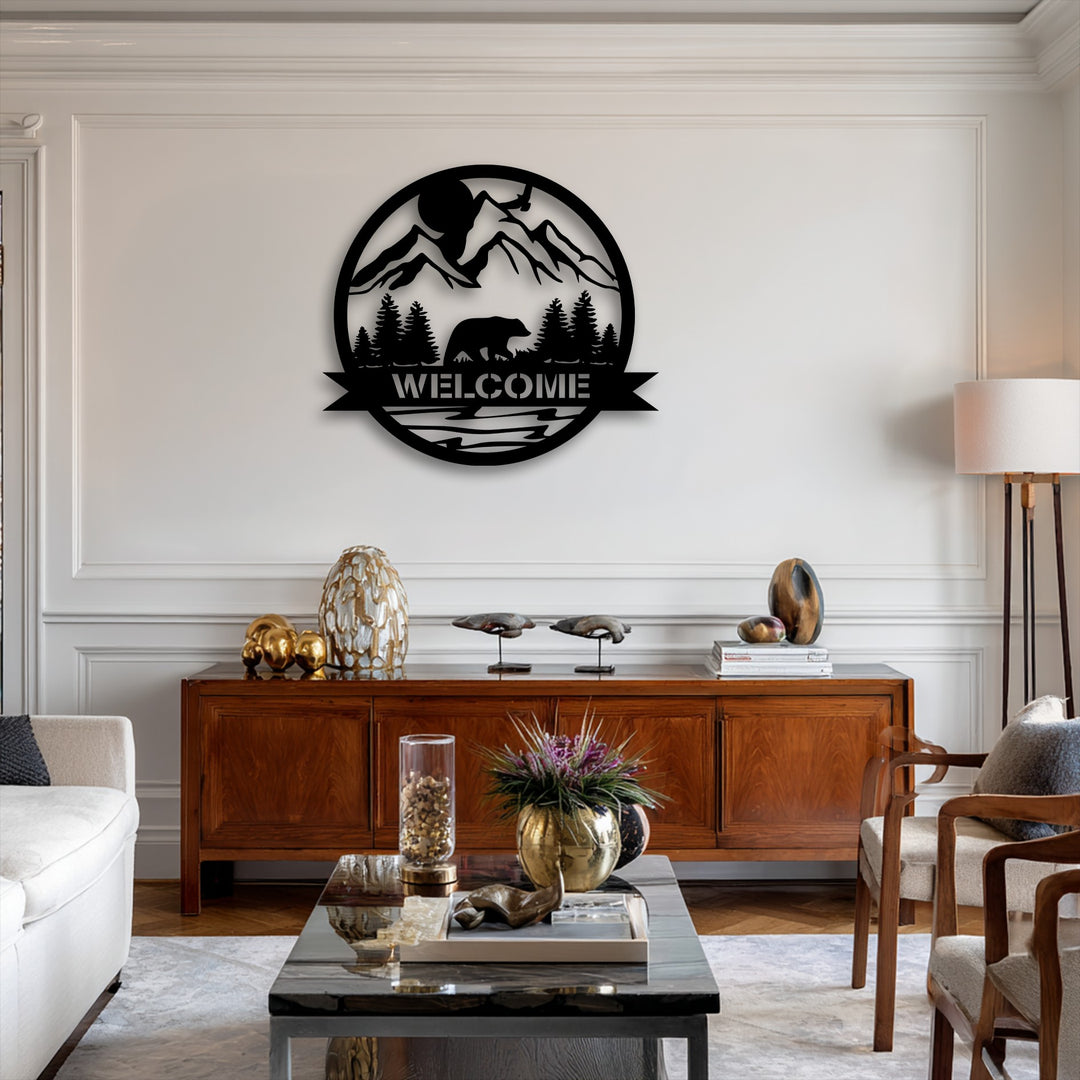 The unique metal wall art realistically details a black silhouette of a bear walking through a detailed mountain forest scene with a 'WELCOME' banner.
