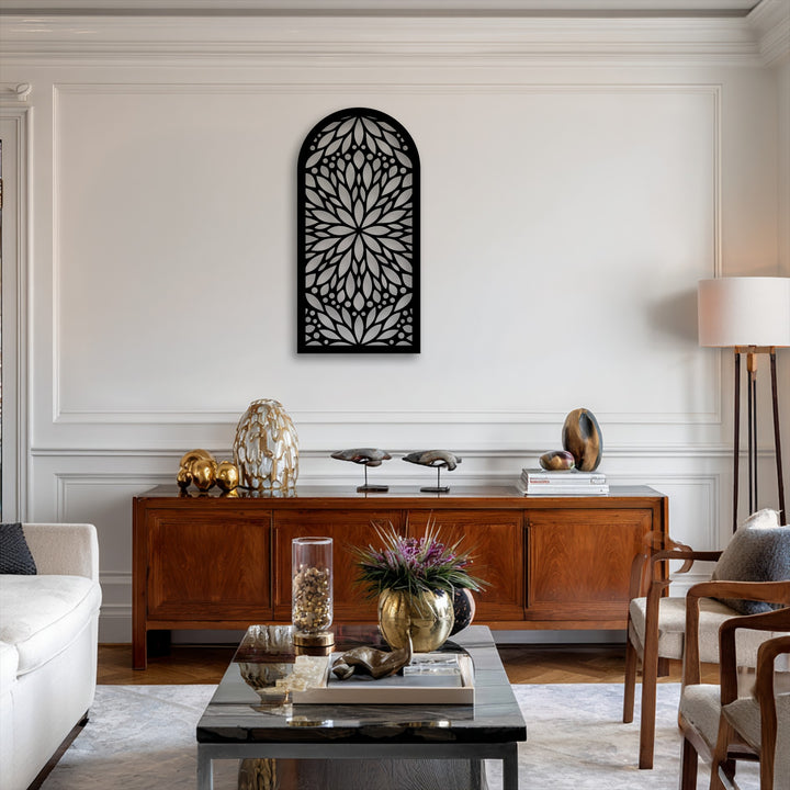 The realistic detail showcases an intricate black decorative metal art piece in an arch shape, featuring a mandala-inspired floral pattern on a white wall.
