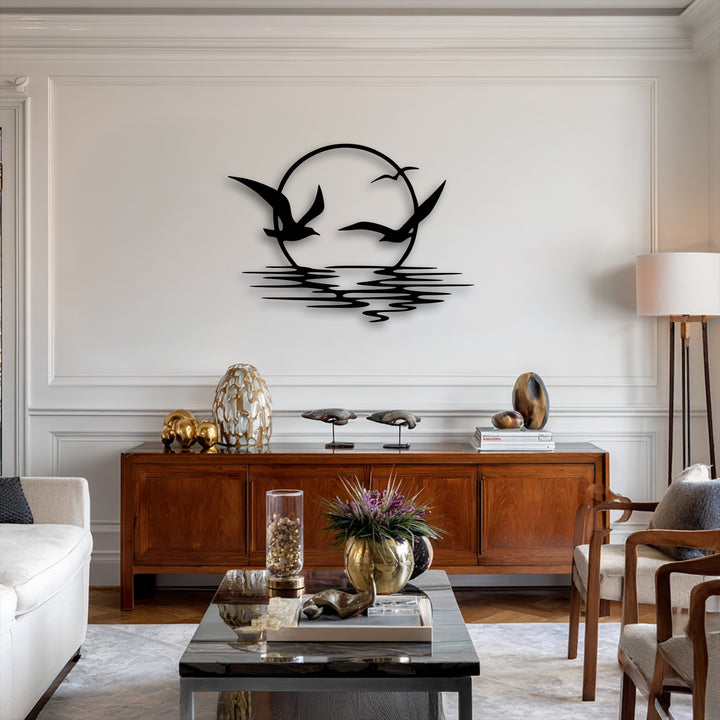 The visual rhythm of three soaring seagulls silhouetted against a setting sun and undulating ocean waves defines this elegant metal wall decor.