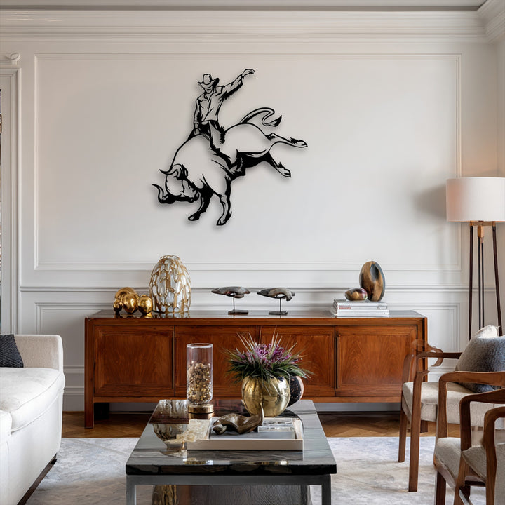 The distinct black edges of the cowboy bull riding metal art for wall pop against the crisp white wall panels, showcasing sharp decorative borders.