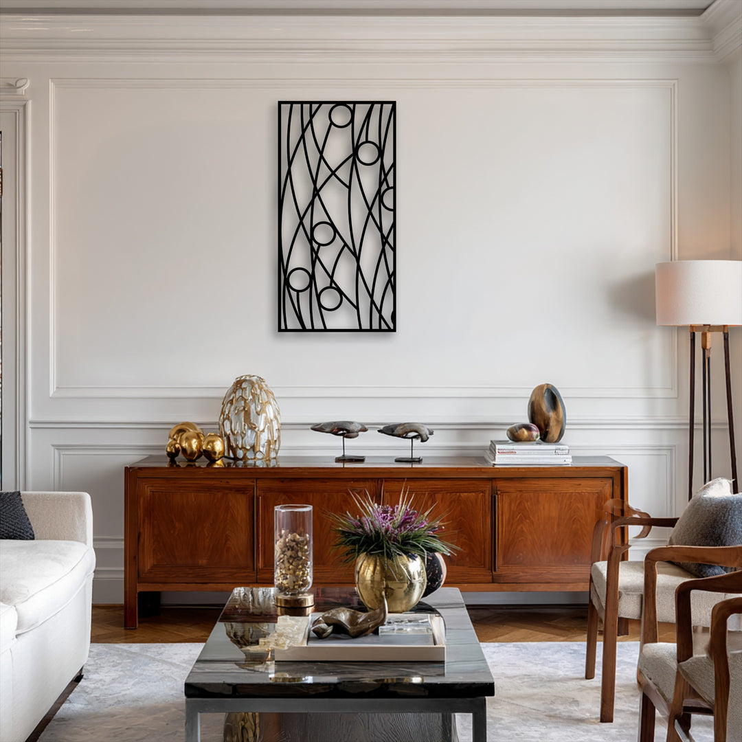 The warm color temperature of the room beautifully highlights the striking black abstract linear geometry metal wall decor on the creamy white wall.