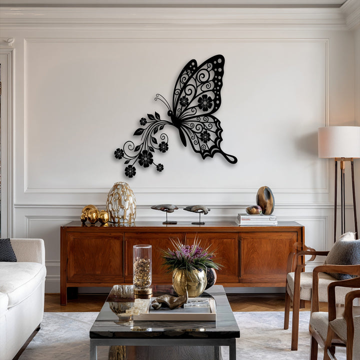 The darkest area highlights an intricate black butterfly metal artwork with delicate floral and scrollwork patterns adorning its wings.