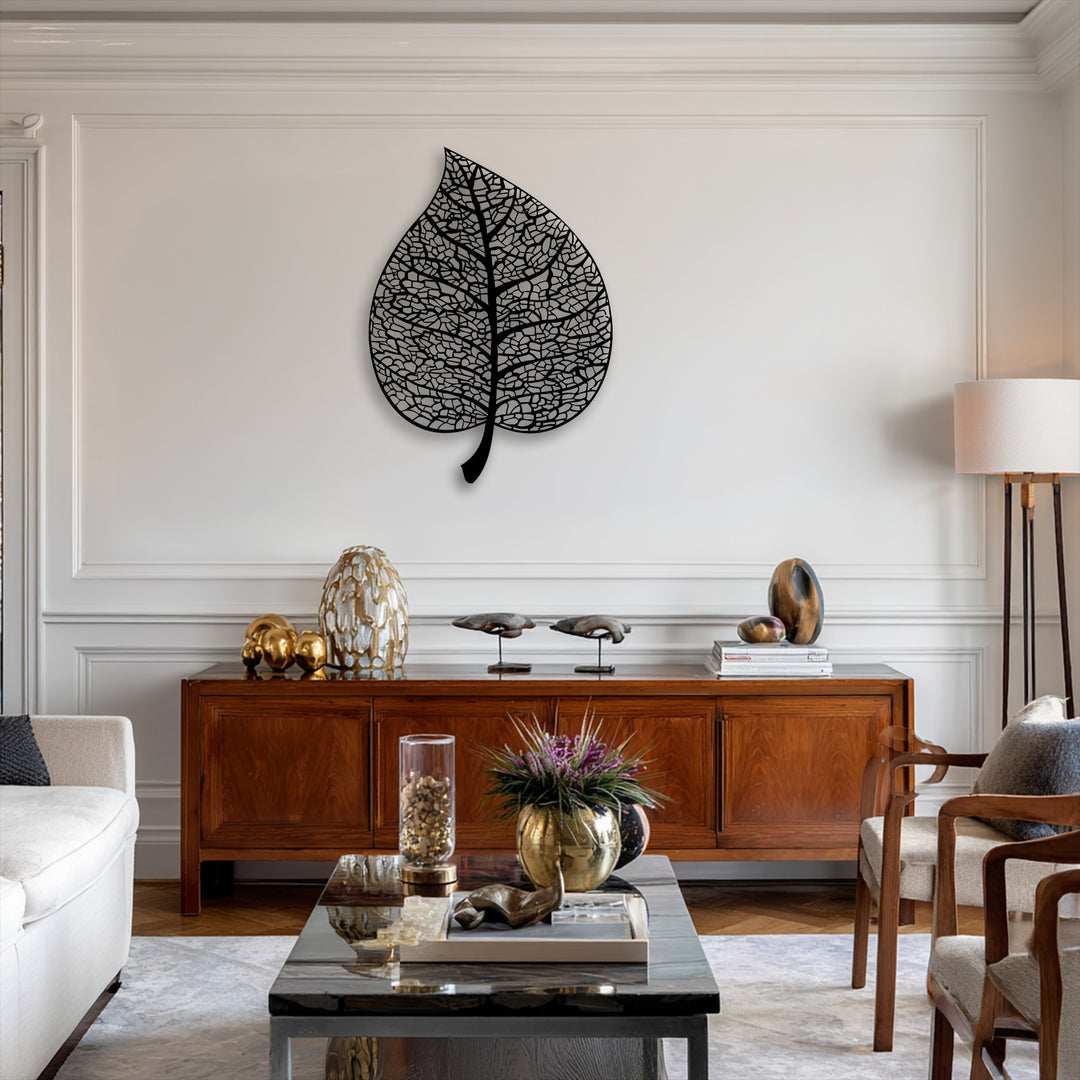 The stillness of the refined decor is enhanced by the serene presence of the intricate botanical leaf unique metal wall art.