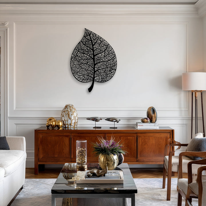 The stillness of the refined decor is enhanced by the serene presence of the intricate botanical leaf unique metal wall art.