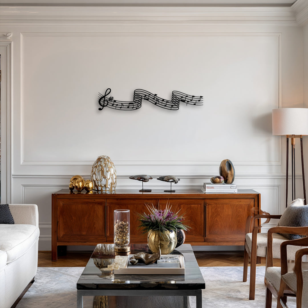 The sleek black decorative metal art featuring flowing musical notes creates a stark contrast against the pristine white wall.