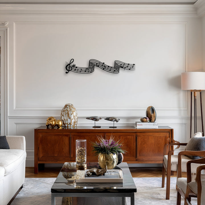 The sleek black decorative metal art featuring flowing musical notes creates a stark contrast against the pristine white wall.