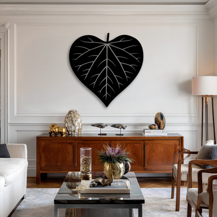The striking transition from the deep black nature heart leaf silhouette metal art for wall to the bright white wall is a captivating design.