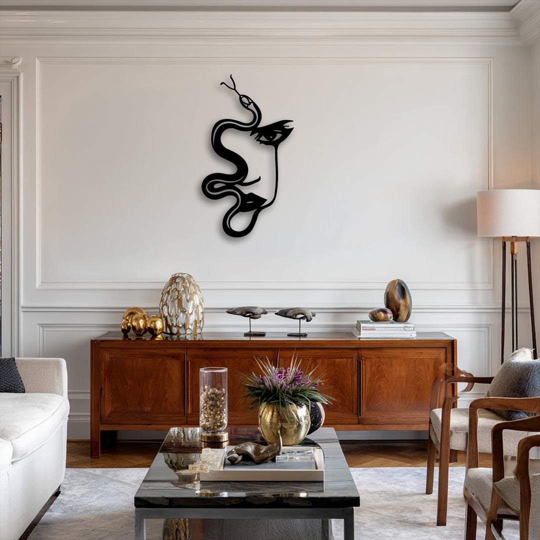 Dramatic light and shadow highlight the striking abstract woman and serpent decorative metal art, forming a captivating silhouette on the pristine wall.