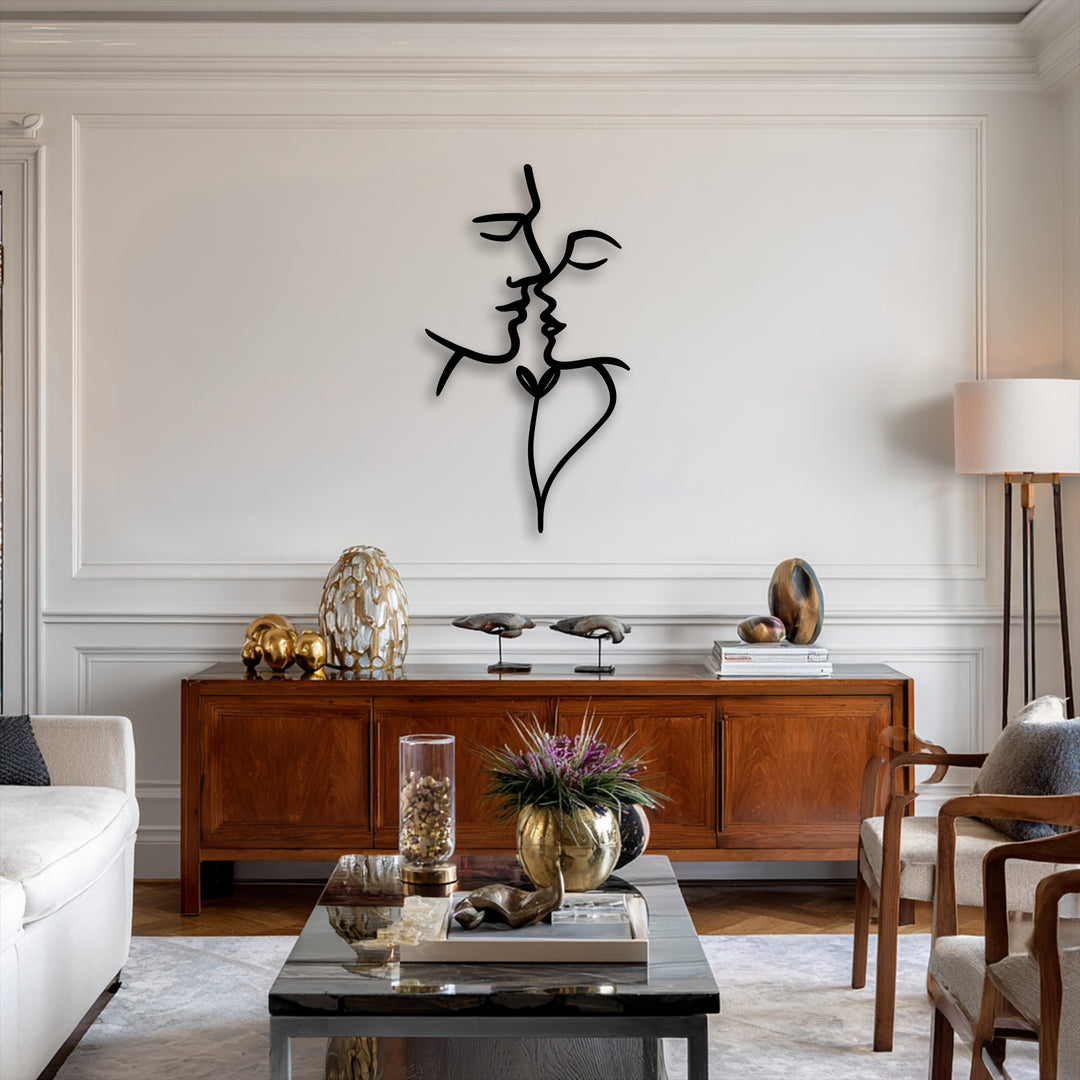 Vertically oriented abstract face metal artwork depicts two intertwined profiles forming a stylized heart shape, ideal for modern interiors.