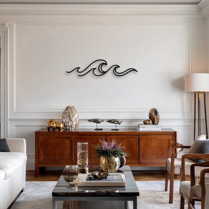 The sleek, dark silhouette of minimalist ocean wave line metal decoration wall art stands out against a light wall above a rich wooden console.