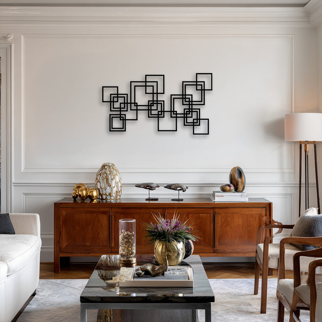 Negative space highlights the crisp lines of the bold black interlocking squares metal decoration wall art against a minimalist wall.
