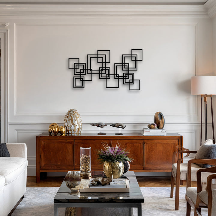 Negative space highlights the crisp lines of the bold black interlocking squares metal decoration wall art against a minimalist wall.