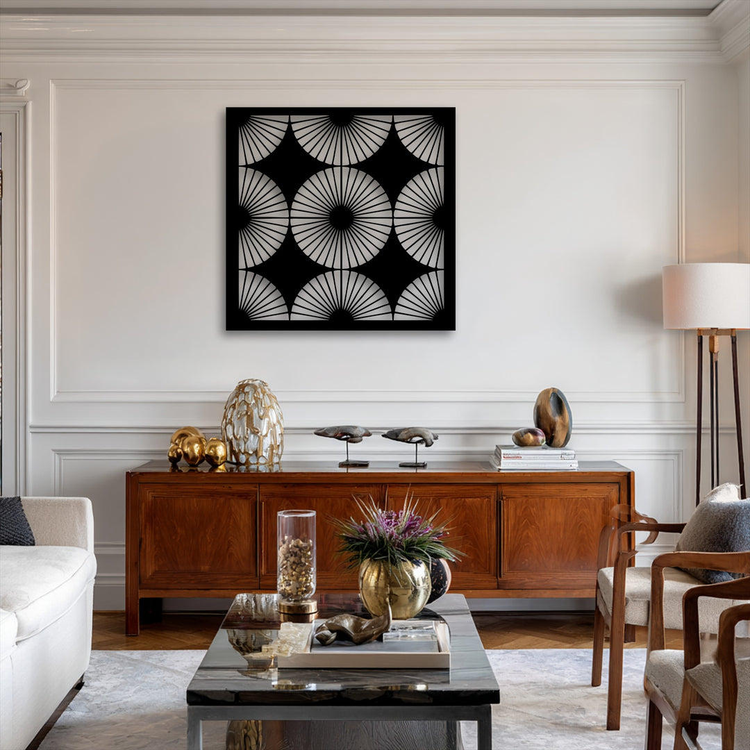 The negative space of the black geometric radiant fan pattern metal artwork reveals the pristine wall, highlighting its modern symmetry.