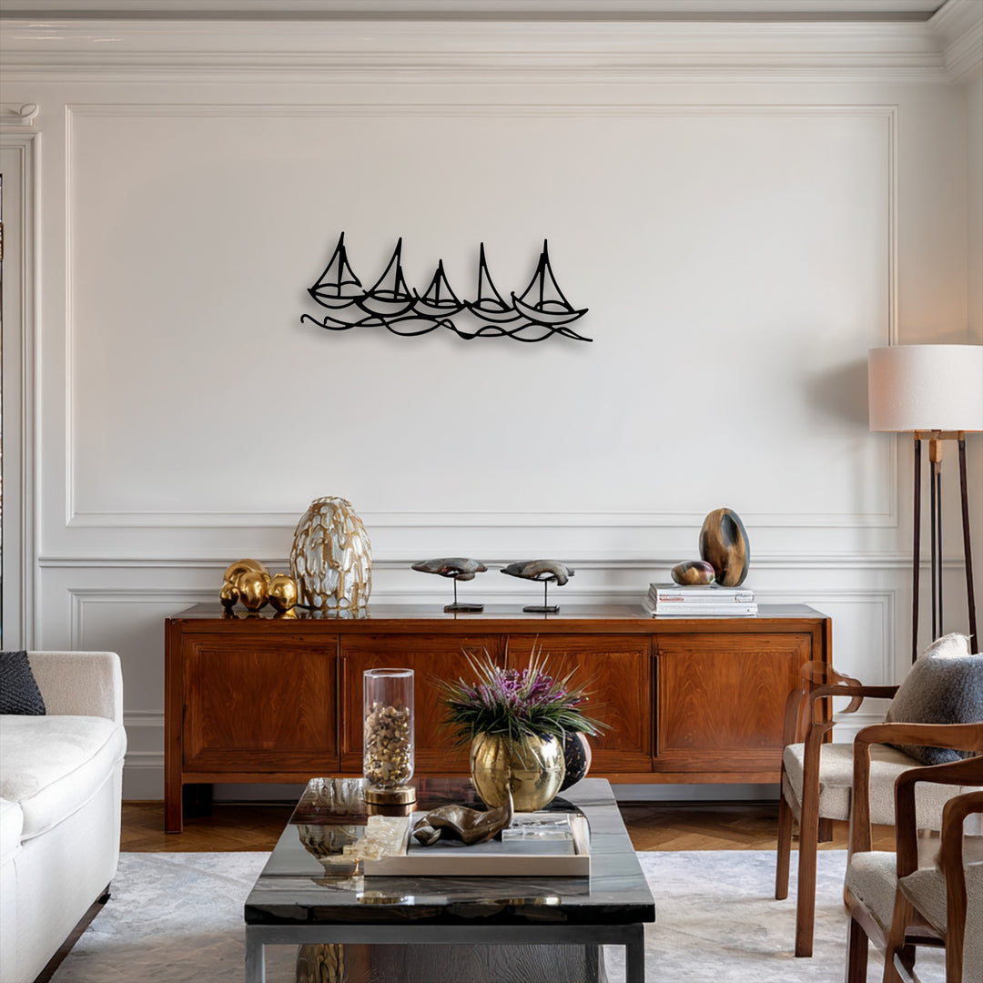 The crisp white background wall, featuring elegant wainscoting and crown molding, beautifully highlights the minimal boat line metal art for wall.