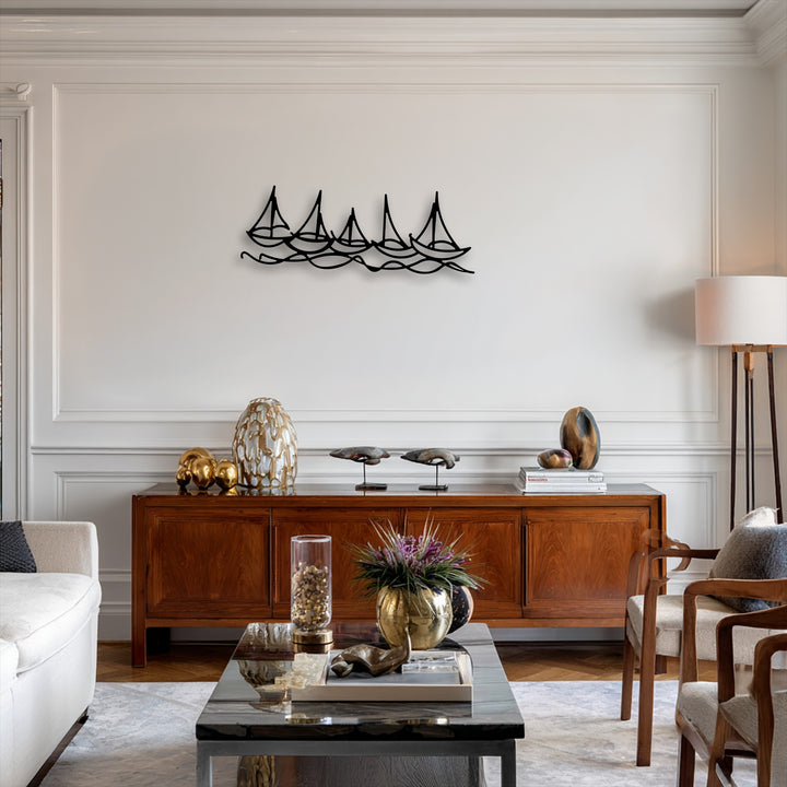 The crisp white background wall, featuring elegant wainscoting and crown molding, beautifully highlights the minimal boat line metal art for wall.