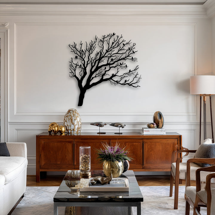 Horizontally oriented, organically shaped metal wall decor featuring a sprawling tree silhouette with numerous birds perched on its bare branches.