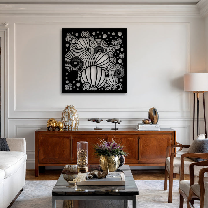 The striking black metal wall decor features abstract white spirals and spherical shapes, creating a bold focal point above a wooden console.