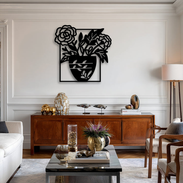 The loudest element is the striking black metal artwork of a floral vase silhouette, providing elegant botanical decor in a modern living room.