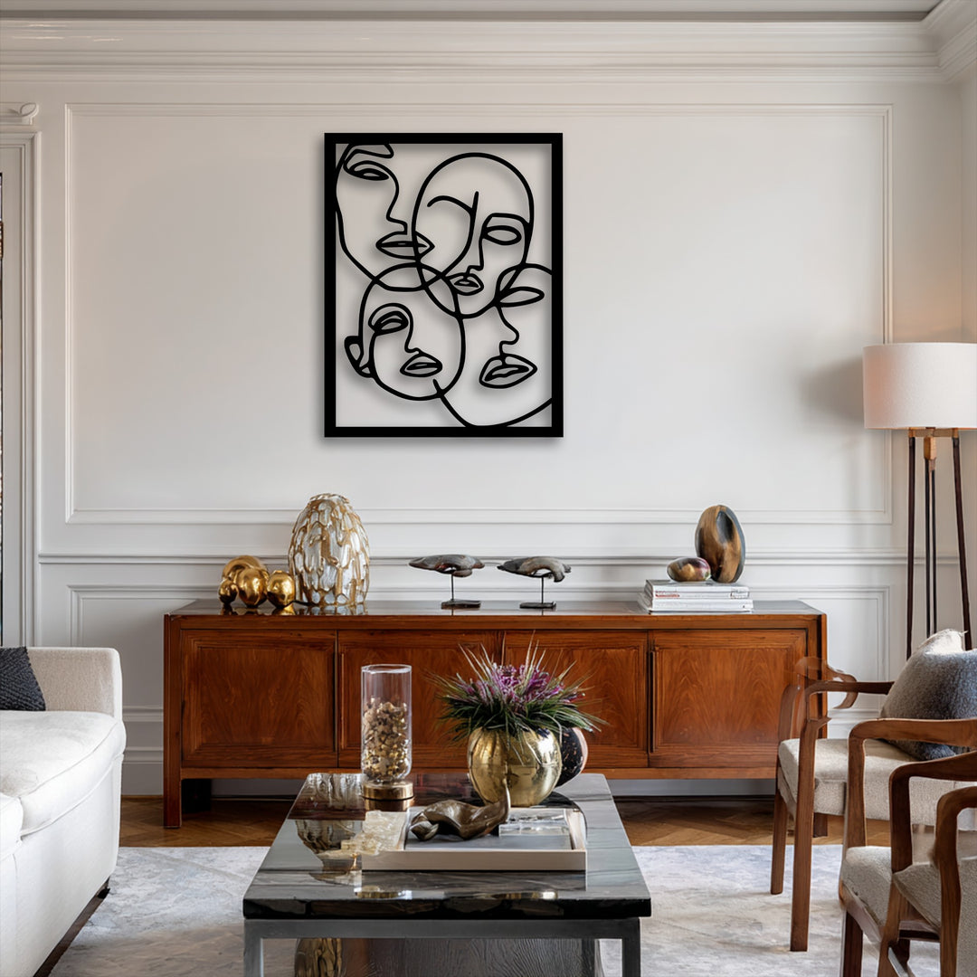 Elegant white paneled walls and crown molding form the background, highlighting abstract faces line art metal art for wall.