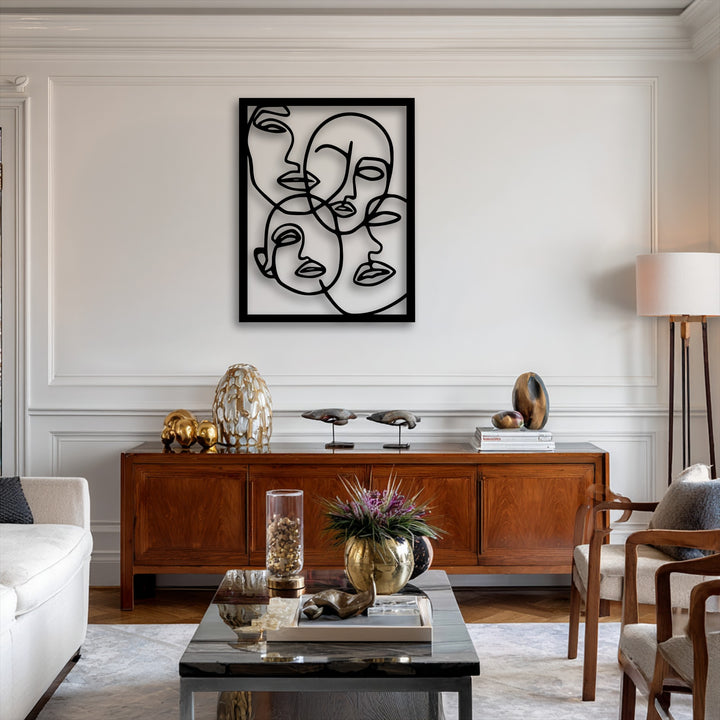 Elegant white paneled walls and crown molding form the background, highlighting abstract faces line art metal art for wall.