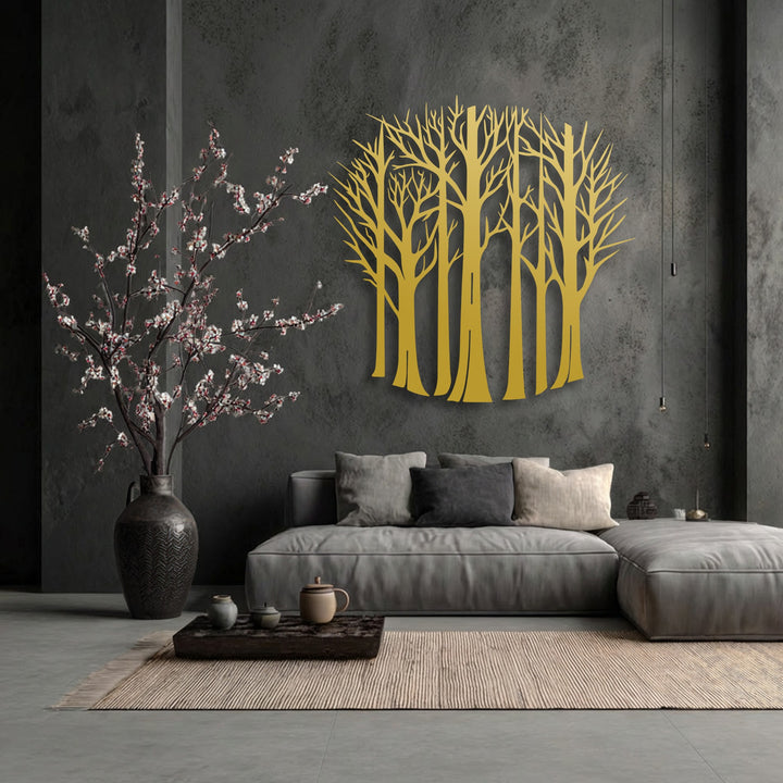 The darkest area of the room features a textured charcoal wall, providing a striking backdrop for the golden bare forest trees metal wall decor.