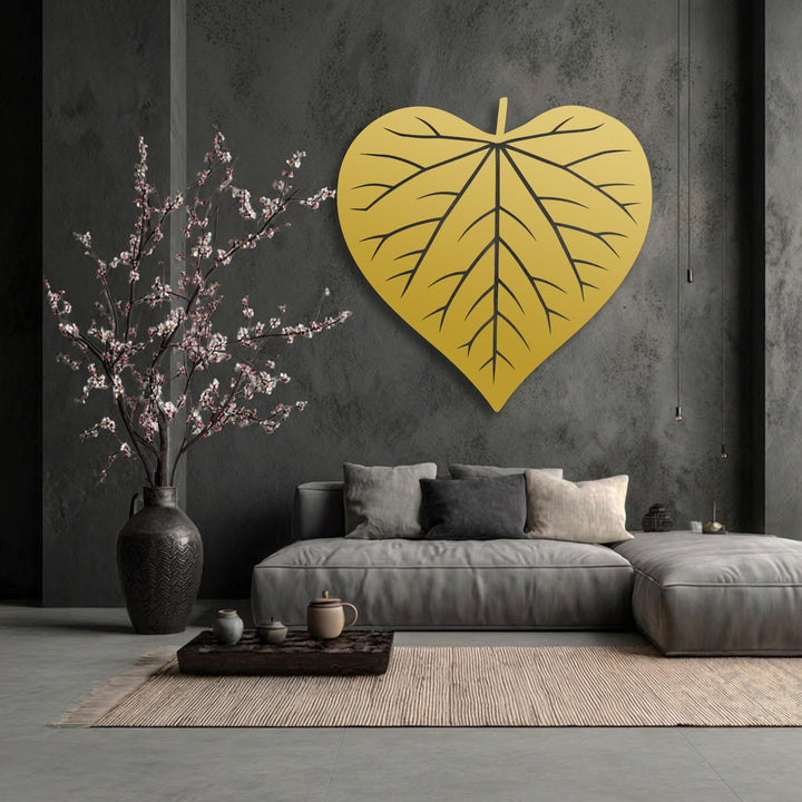 The striking transition from charcoal grey walls to the brilliant golden heart-shaped leaf creates a captivating focal point of metal art for wall.