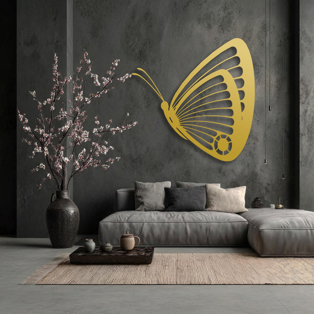 Dark charcoal gray walls frame an elegant golden butterfly metal art for wall, with a blooming tree and light grey sofa.