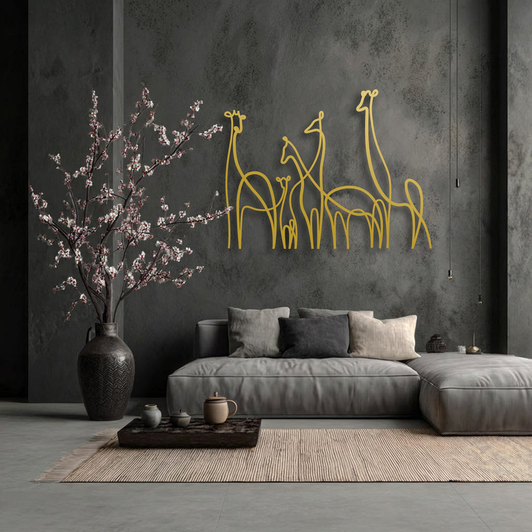 The background features a dark, textured grey wall, providing a modern backdrop for elegant metal wall decor depicting a minimalist giraffe family.