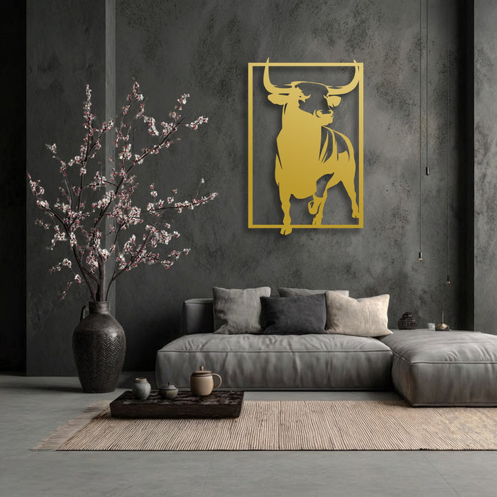 The dark, textured wall serves as a rugged background, enhancing the unique metal wall art of the powerful golden bull.