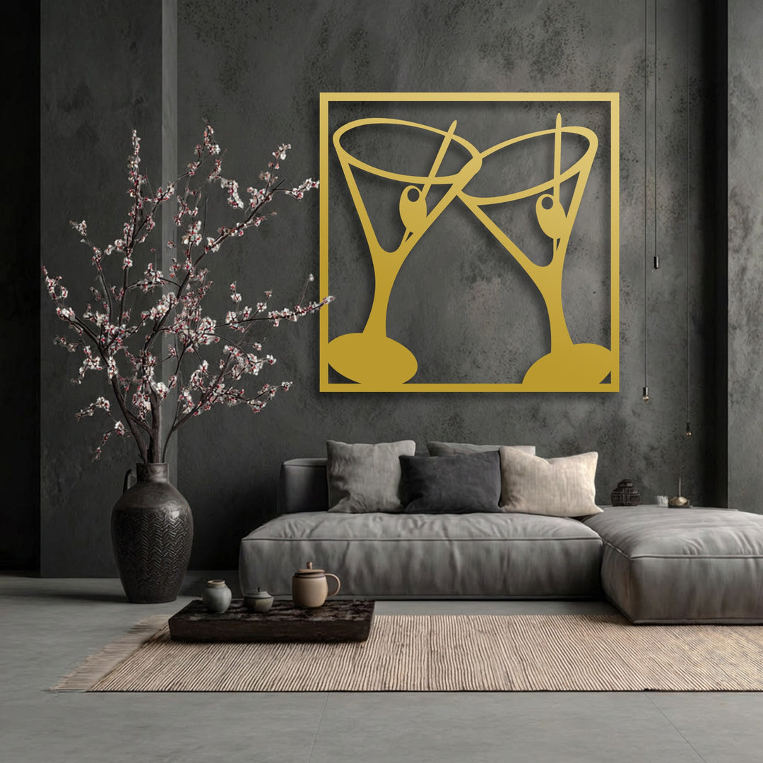 Golden metal decoration wall art displaying modern cocktail glasses clinking, prominently placed on a textured dark wall.