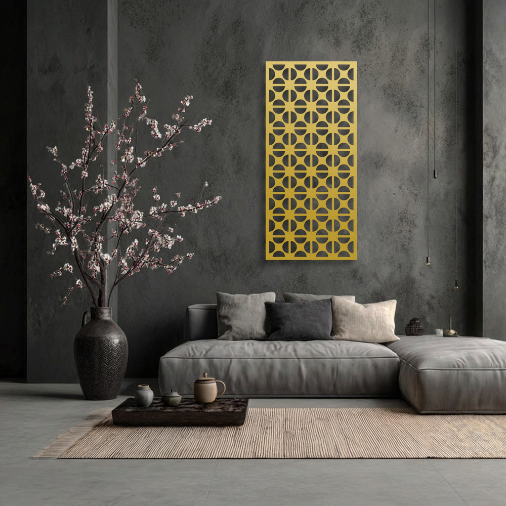 The striking golden geometric circle pattern, a unique metal wall art piece, brightly contrasts a dark, textured wall.