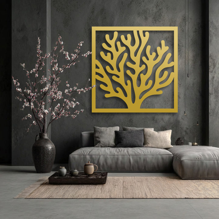 The striking golden coral framed decorative metal art piece, with its organic shapes, serves as a bold focal point on the dark wall.